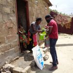 One of TOSF staff handing over the donations to a need lady. 